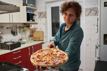 Woman showing her homemade pizza © Xalanx
