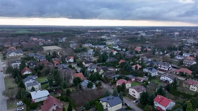 Aerial Osielsko parish city Poland slide 2. Modern city based on historical Polish architecture. Apartment complex, school, sports fields, parks and individual private residential homes.