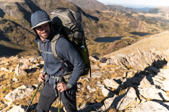 Weekend explorer scanning horizon over scenic alpine valley