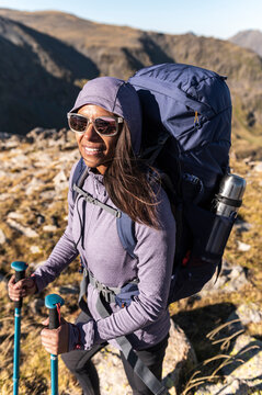 Unplugged explorer moving uphill with minimalist alpine gear