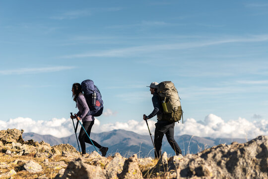 Mindful explorers advancing together above distant cloud layers