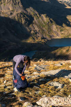 Content outdoor woman wearing technical layers in serene highland setting