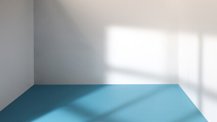 An empty room with sunlight streaming through a window.