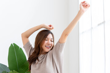 Refreshed woman enjoying morning wellness routine at home