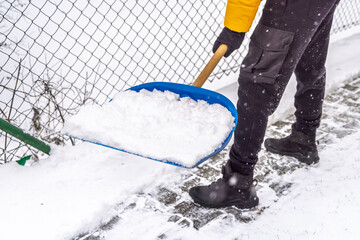 Removing snow from the pathway and street, winter cleaning