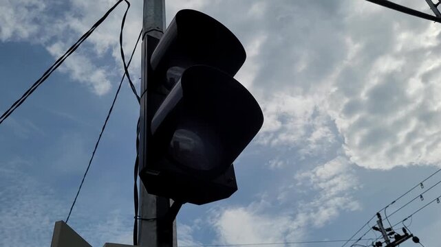 Bleeping traffic hazzard lamp with sky background