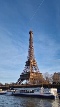 Paris, France - December 10, 2025: View from a cruising boat trip along the Seine river to the breathtaking Eiffel Tower. The iconic Parisian landmark as global attraction. French trip symbol