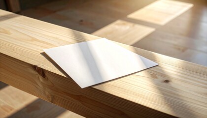Blank square card resting on a sunlit wooden bench, casting a subtle shadow, evoking simplicity and potential