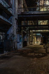 Abandoned factory interior with overhead platforms