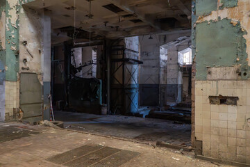 Abandoned industrial hall interior with damaged walls