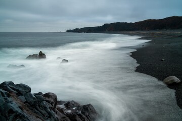 view of the Djupalonssandur black sand and pebble beach on the Snaefellsnes Peninsula