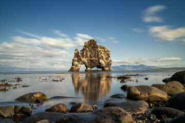 view of the iconic Hvitserkur sea stack in northern Iceland with reflections in the water