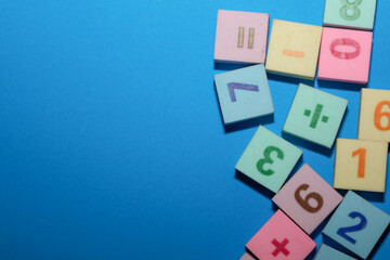 ​A vibrant educational composition of multicolored toy blocks featuring numbers and arithmetic...