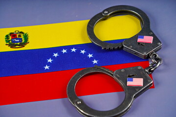 The flag of Venezuela and handcuffs with the flag of the USA.