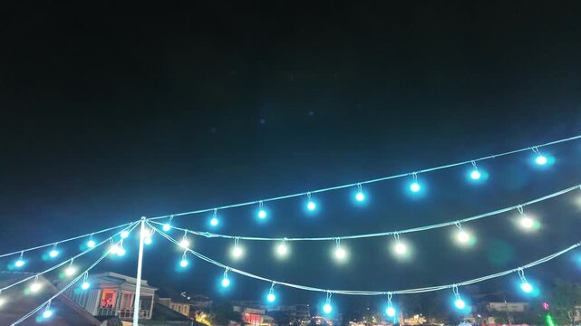 Camera video of string lights glowing at night market