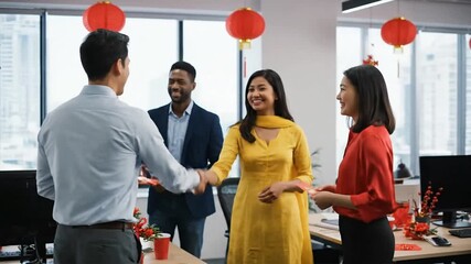 Colleagues greeting and shaking hands in a modern office decorated for a cultural celebration
