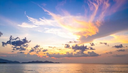 Ocean under a vibrant sunset with colorful, dynamic clouds reflecting on calm waters