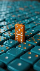 One orange domino standing out among many blue dominoes in a row, concept of difference and standing out