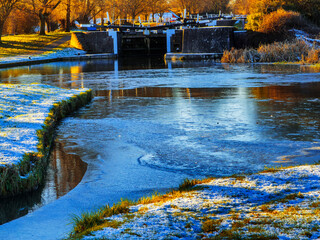 uk canal in winter with snow and frost