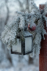 A Christmas decorations on a pole that carries a lantern on a freezing winter day.