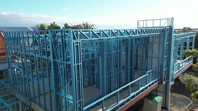 Steel frame house under construction, modern residential building site
