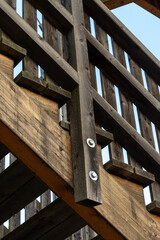 Wooden railings and beams with bolted connections in the construction of the observation deck.