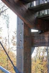 Vertical wooden stand with massive bolted fasteners of the structure.