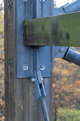 Horizontal wooden beam with metal diagonal links.