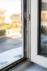 Dirty plastic window. Dust-covered plastic window frame and sill with dirt buildup and stains. Spring home cleaning concept