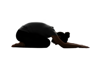 Woman in silhouette performing yoga childs pose on black background image