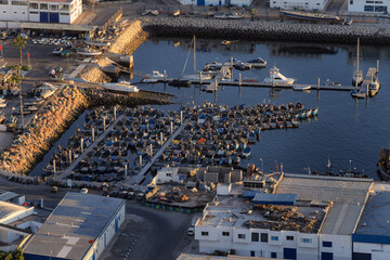 Harbor Marina With Rowboats Docked Along Breakwater Under Industrial Waterfront, Agadir, Morocco