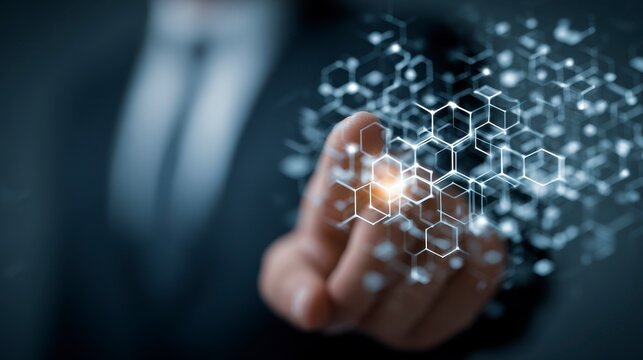 A person in a suit touches a glowing digital network of interconnected hexagonal shapes, a concept of technology - Powered by Adobe