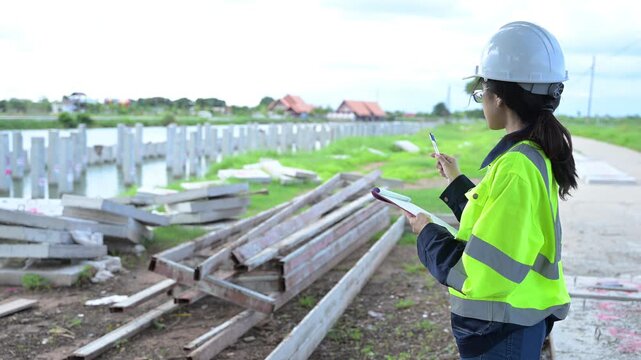Asian engineer working at site of a large building project,Thailand people,Work overtime at construction site,Team of engineer discus at site
