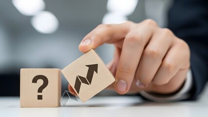 Navigating uncertainty A business hand places a growth strategy block next to a question mark, symbolizing decision-making and the path to progress and success