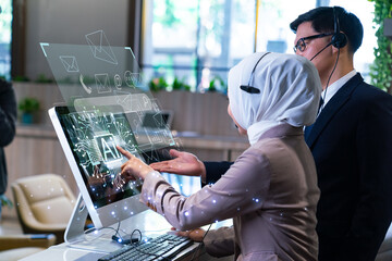 Muslim businesswoman wearing hijab and headset utilizing futuristic AI hologram interface for customer support in modern office.