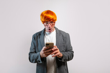 Adult man looking at smartphone with shocked expression