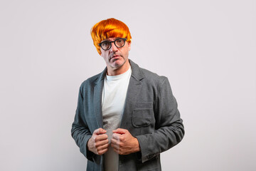 Man wearing orange wig and glasses looking at camera