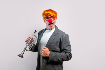 Entertainer wearing wig and clown nose playing trumpet