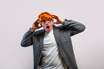 Stressed man in orange wig reacting with shock