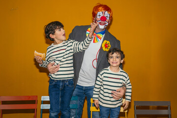 Clown playing with children at birthday party