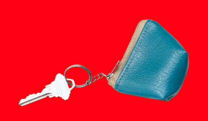 A slilver key in blue keychain isolated on red backgroound with clipping path