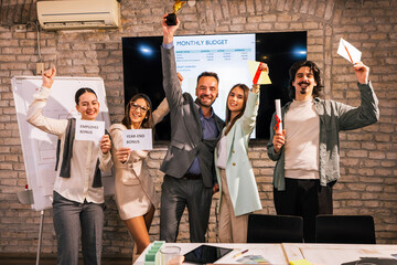 Diverse Business Team Celebrating Bonus Distribution in Modern Office