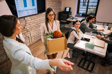 Young businesswoman leaving office after being fired