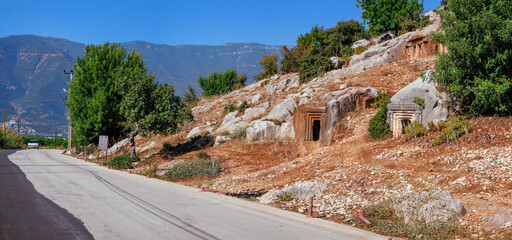The ancient Lycian rock tombs of Demre (Myra) are carved into the red cliffs: facades with Doric columns and pilasters over terraces, a classic symbol of Lycian culture in Turkey