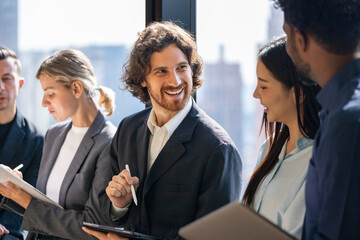 Team of diversity business people are discussing over new strategic strategy project on investment real estate while brainstorming around the office building for new project and planning