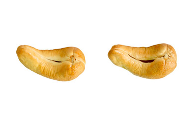 A set of two roasted or baked cashew nuts isolated on white background with clipping path