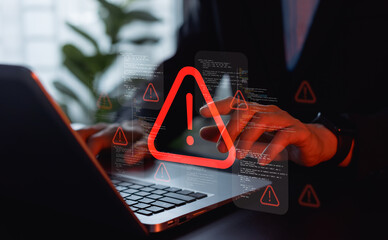 Cyberattack and data breach warning shown on laptop as businessman reacts to virus alert, highlighting malware threats, security risks, and the need for strong online protection.