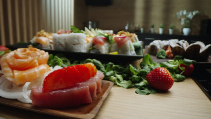 Delicious sushi platter with fresh salmon, tuna, and vibrant strawberries