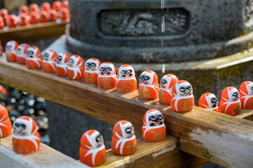 Daruma doll with Japanese character (Kanji) meaning 'Victory' in Katsuo-ji temple. Temple of Daruma Dolls, Famous travel destination for sightseeing Kansai.