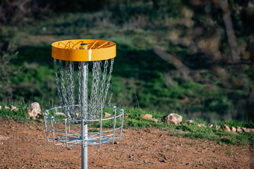 yellow disc golf basket on the left in portugal